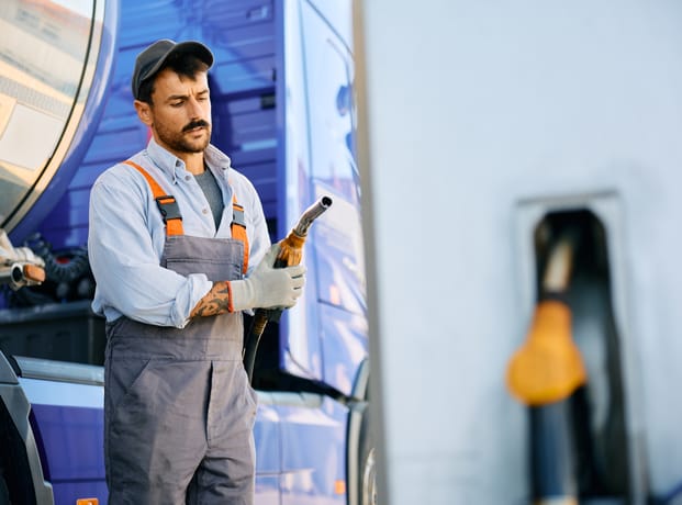 Worker refueling a truck.