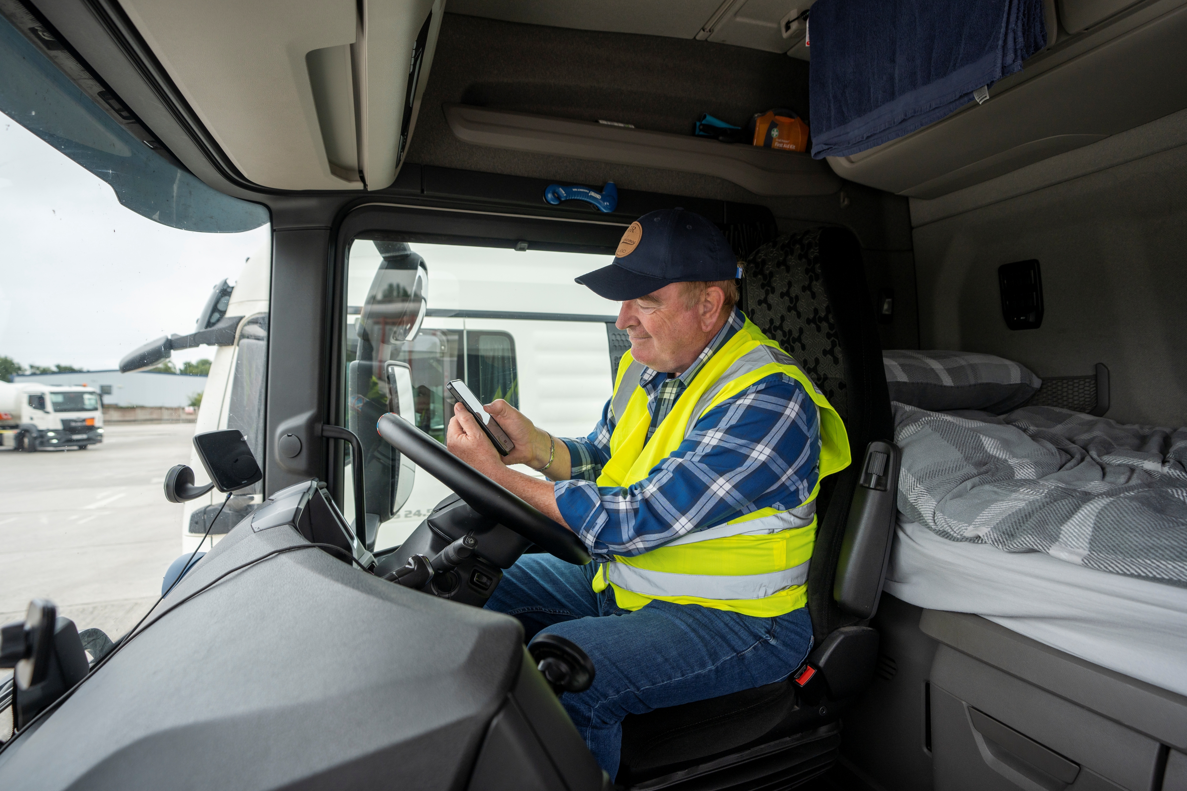 Truck driver in cab using intruck